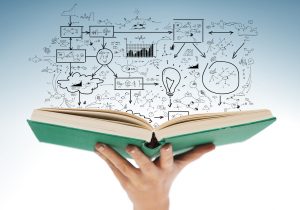 19 Useful Personal Finance Books Tailored for Teens 28 education and book concept - close up of female hand holding open green book with big plan